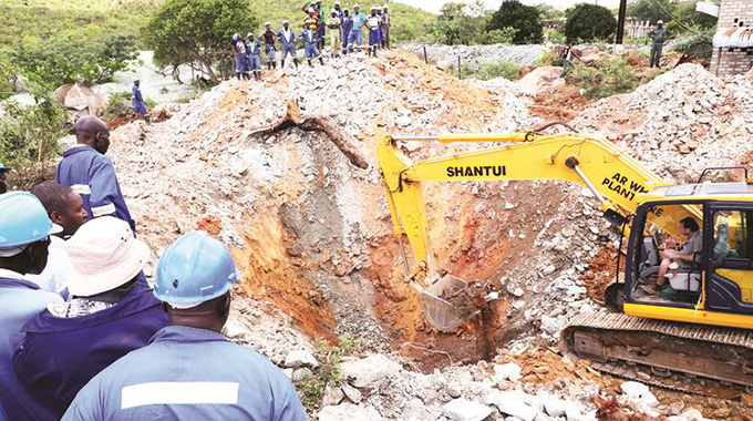 Workers try to rescue four miners who are feared dead at Esikhoveni Mine in Esigodini, Matabeleland South Province, yesterday. — Picture: Eliah Saushoma