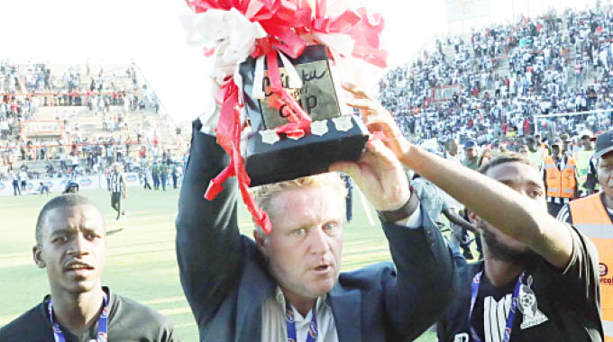 Highlanders coach Pieter de Jongh parades the Chibuku Cup to supporters with the assistance of Brian Banda and Andrew Mbeba recently
