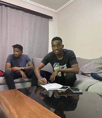 Ovidy Karuru signing the Stellenbosch contract at his home on Saturday