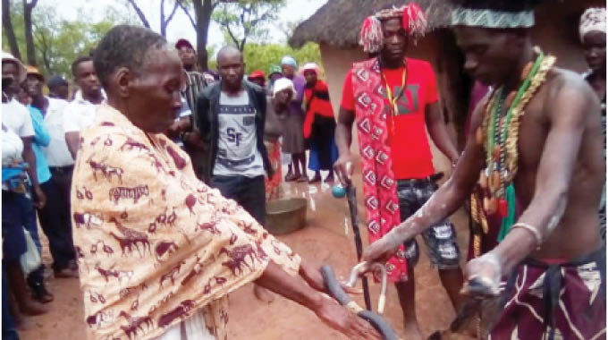 Laiza Ndlovu and a witch-hunter during the cleansing ceremony