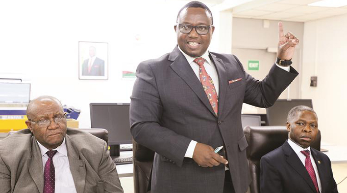 Home Affairs and Cultural Heritage Minister Kazembe Kazembe (centre) addresses the media while flanked by his deputy, Mike Madiro (left) and Registrar-General Clement Masango after a familiarisation tour of the passport production plant in Harare yesterday. — Picture: Memory Mangombe