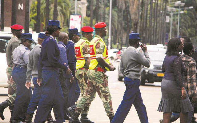 Zimbabwe Republic Police and members of the Zimbabwe National Army patrol in the Central Business District during a joint operation in Harare in November 2017. — Picture by Justin Mutenda