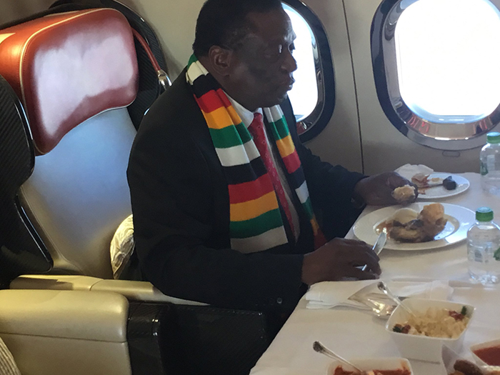 President Emmerson Mnangagwa eating meat on a private jet