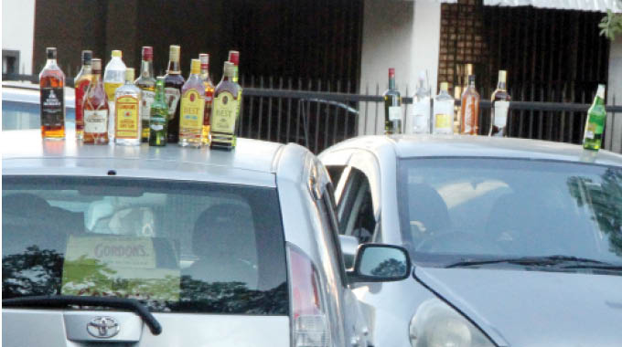 An assortment of whiskeys and vodkas displayed on top of cars for sale by illegal vendors along George Silundika Street in Bulawayo