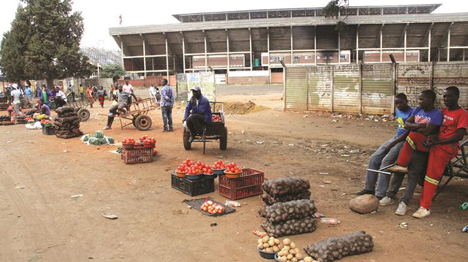 Vendors sell potatoes and tomatoes outside Rufaro Stadium in Mbare, Harare, yesterday. The City of Harare recently evicted the vendors from the stadium’s parking space to pave way for renovations ahead of the start of 2020 Premier Soccer League. — Picture: Kudakwashe Hunda