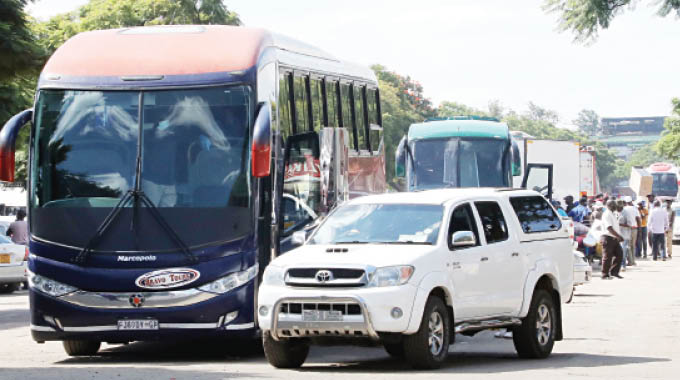Cross border buses rank along George Silundika Street in Bulawayo to pick up travellers to South Africa yesterday