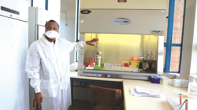 Laboratory scientist Tatenda Takawira showing Covid-19 samples in a Biological Safety Cabinet (BSC). The BSC is an enclosed, ventilated laboratory workspace for safely working with materials contaminated with, or potentially contaminated with, pathogens requiring a defined biosafety level