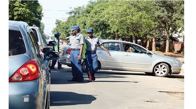 The Zimbabwe Republic Police descended heavily on errant motorists as many were refused entry into the central business district. The picture taken yesterday morning shows traffic police officers turning back some of the motorists along Fife Street in Bulawayo