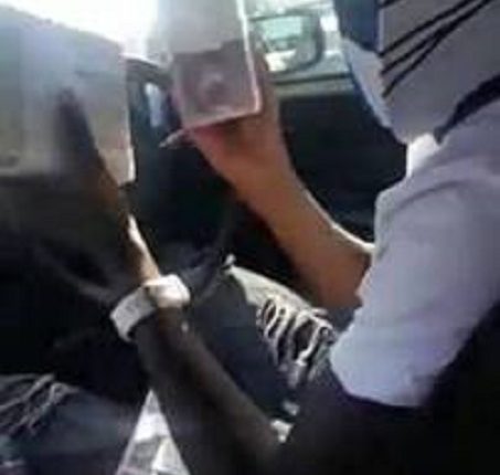 Wanted...The man is seen flaunting brand new $5 notes
