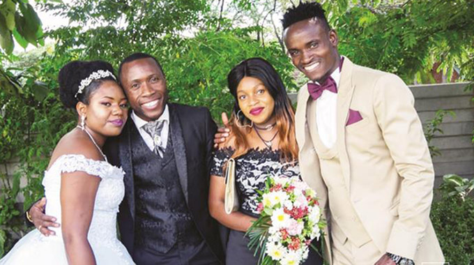 GREEN COMPANY . . . Ronald Pfumbidzai (right) and his bride Graduate (left) join his former CAPS United teammate, Hardlife Zvirekwi (second from left) and his wife Sarudzai, for a photo on the day the Warriors left back wedded his wife in Harare in January this year
