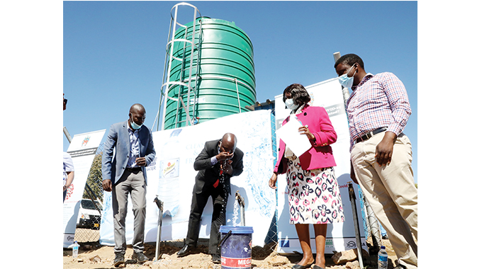 Bulawayo Mayor Clr Solomon Mguni launches one of the water kiosks built in partnership with Danish Church Aid and Schweppes Holdings Africa in Pumula South, Bulawayo, yesterday. Looking on (from left) are Schweppes acting business executive southern region head Mr Nash Mashavane, Bulawayo Provincial Coordinator Mrs Khonzani Ncube and Danish Church Aid country director Mr Ringisai Chikohomero.
