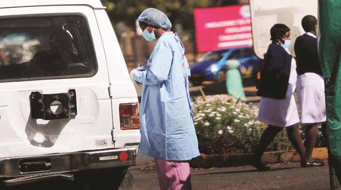 A health worker screens a motorist entering Parirenyatwa Group of Hospitals in Harare yesterday. The hospital has reportedly recorded several positive cases of Covid-19 among both patients and staff. — Picture: John Manzongo