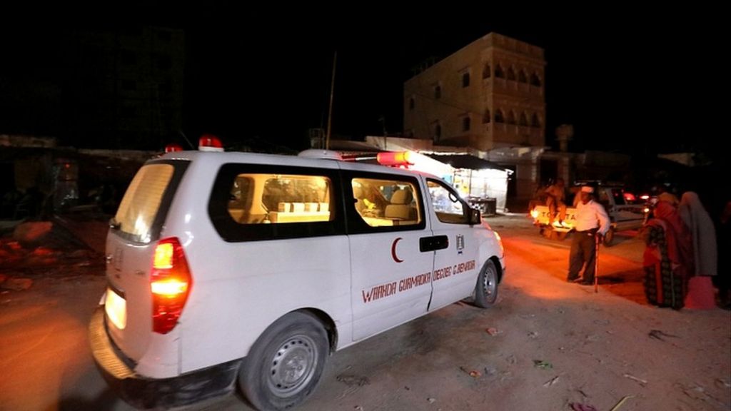 At least five people were killed in a gun and bomb attack by suspected Al-Shabaab fighters on an upscale beachfront hotel in Somalia's capital on Sunday, officials and witnesses said.
