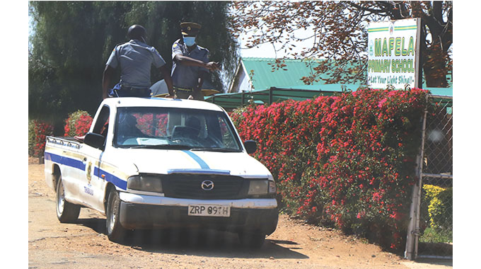 A police vehicle passing by the school gate after retrieving the body of the late Mpilo Khumalo who allegedly hanged himself at Mafela Primary School in Nkulumane suburb on Tuesday