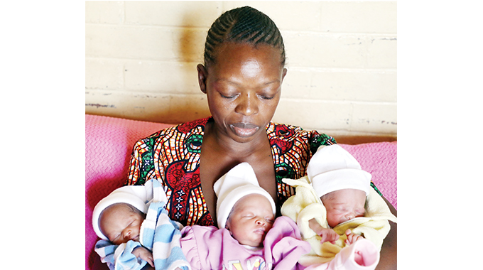 Mrs Sikhulekile Moyo holds her triplets at the family home in Magwegwe North, Bulawayo, yesterday