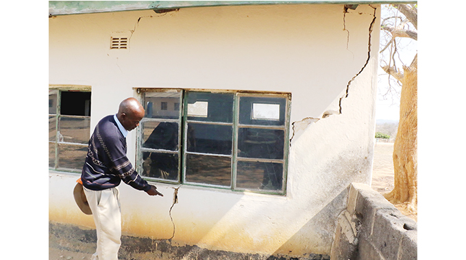 SDC Chairman Dumisani Luphahla showing one of the classroom blocks with a huge crack