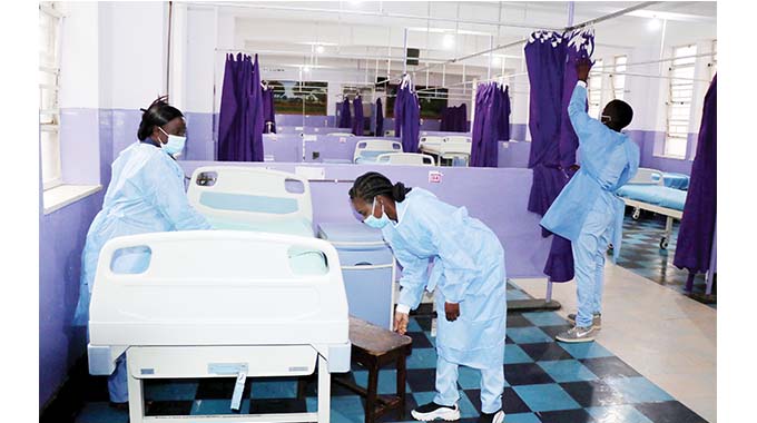 Mpilo Hospital nursing staff spread bed linen in the newly refurbished C1 Ward — (Picture by Obey Sibanda)