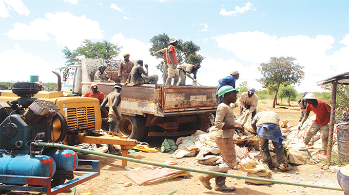 File picture of youth loading gold ore at Peace Mine