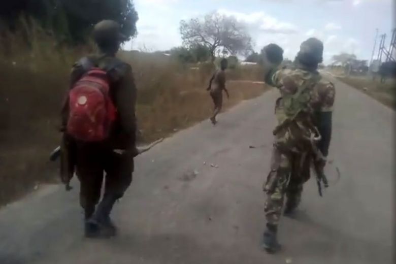 Moments from gruesome killing ... Men wearing Mozambican army uniform stalking a pregnant woman before they take turns to shoot her