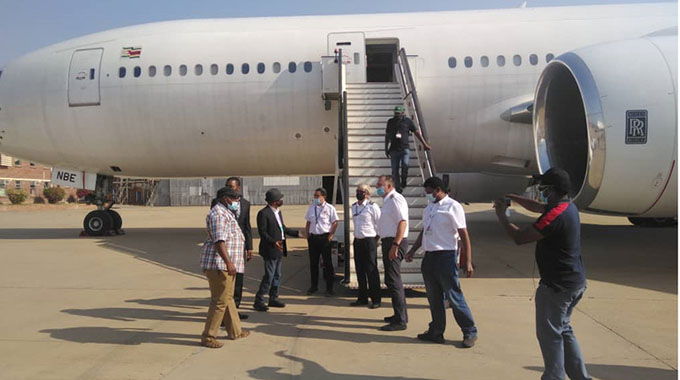 Transport and Infrastructural Development Minister Joel Biggie Matiza (third from left) speaks to pilots at Robert Gabriel Mugabe International Airport yesterday, soon after the landing of the Boeing 767 aircraft, a new addition to the Air Zimbabwe fleet.