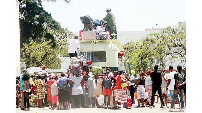 Form Three and Five pupils from different schools board buses taking them to their respective schools in Bulawayo yesterdy ahead of the phase two reopening of schools today
