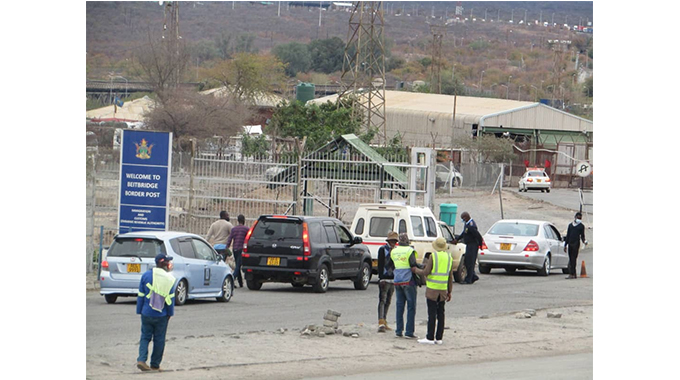 Immigration officers screen travellers at a checkpoint at Beitbridge Border Post yesterday