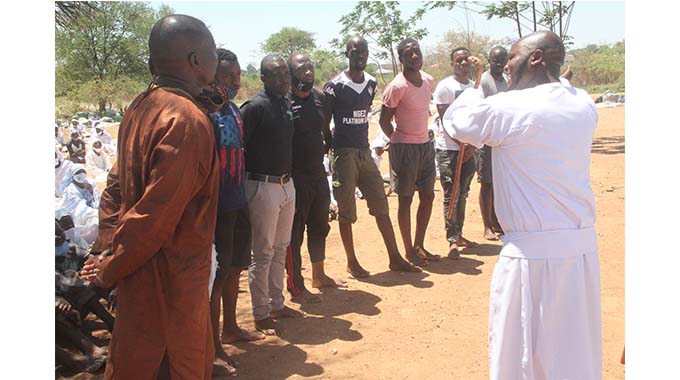 Johane Masowe weChishanu sect leader Madzibaba Emmanuel Mutumwa (right) speaks to members of Highlanders FC first team during a three-day church conference at his shrine in Selbourne Park on Sunday