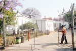 Touts ‘hassle’ back at passport offices A security guard closes the gate at Bulawayo Passport Offices after the entry of the required number of people to be served yesterday