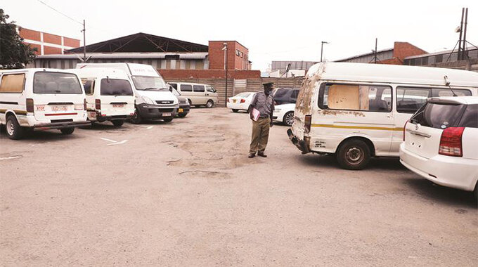Acting Harare provincial police spokesperson Assistant Inspector Simon Chazovachii shows some of the impounded cars at Harare Central Police Station for not following Covid-19 restrictions in Harare yesterday. — Picture: Justin Mutenda