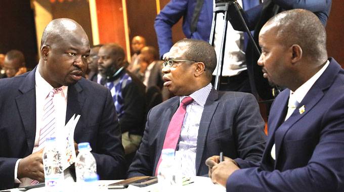 Finance and Economic Development Minister Mthuli Ncube (centre) speaks to Permanent Secretary George Guvamatanga (left) while Chief Director Communications and Advocacy Clive Mphambela looks on at the Mid-Term Policy Review breakfast meeting in Harare yesterday. — (Picture by Justin Mutenda)