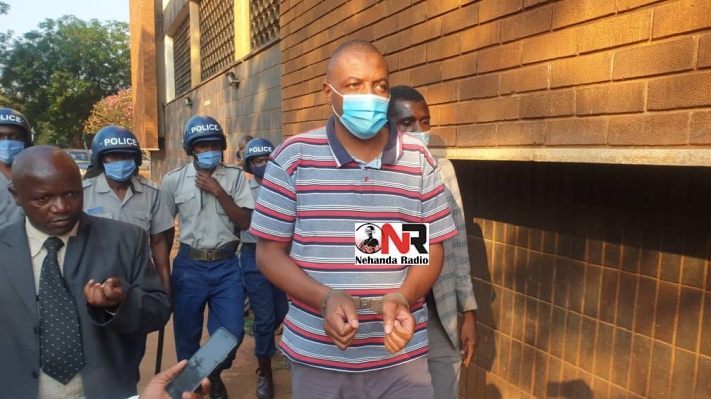 Journalist Hopewell Chin'ono being led to court by riot police