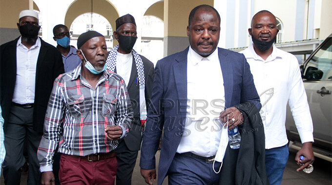 Michelle , "Moana's" father, Ishamel Amuli (left) flanked by his lawyer, Advocate Arshiel Mugiya arrive for High Court proceedings yesterday as judgement for Moana's burial was indefinitely reserved in Harare.- (Picture by Edward Zvemisha)