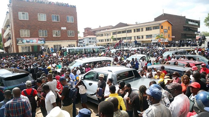 Scores witness the funeral procession of the late Harare socialite Genius “Ginimbi” Kadungure in Harare yesterday. — Picture: Believe Nyakudjara