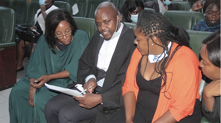 Michelle "Moana" Amuli 's mom, Yolanda Kuvawonga (left) listens to applicant lawyer, Advocate Paidamoyo Madondo (centre) during court proceedings on funeral arrangements for video vixen, Michelle "Moana" Amuli at the High Court in Harare.- (Picture by Edward Zvemisha)