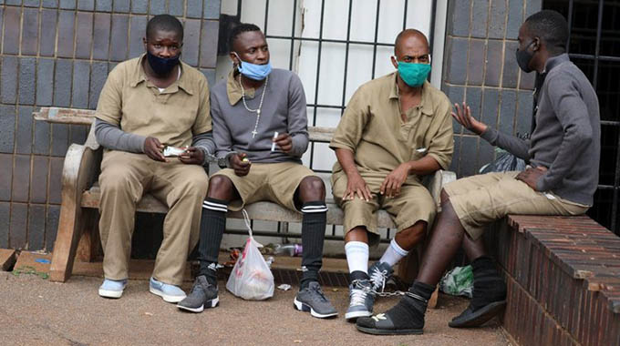 Musa Taj Abdul (second from right) and other suspected armed robbers at Harare Magistrates court yesterday