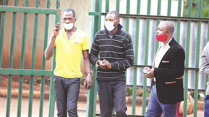 Tichaona Njowa and Job Njowa who are part of the US$2,7 million heist gang appear at the Harare Magistrates Court yesterday