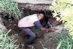 Family endures six years of fear after building house atop a disused mine Mr Justin Chimedza inspects the disused mine shaft that has started caving in (Pictures by Thupeyo Muleya)