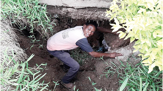 Mr Justin Chimedza inspects the disused mine shaft that has started caving in (Pictures by Thupeyo Muleya)