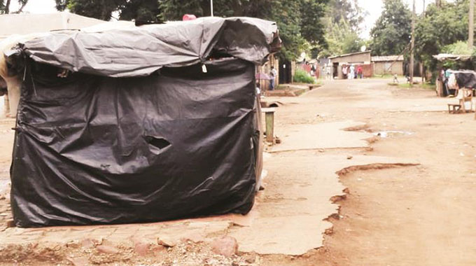 A makeshift tuckshop has been built in the middle of a tarred road in Dzivaresekwa 3 next to a council beerhall