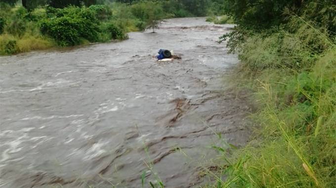 Toyota Hilux double cab vehicle was swept off a flooded bridge on Gweru River 