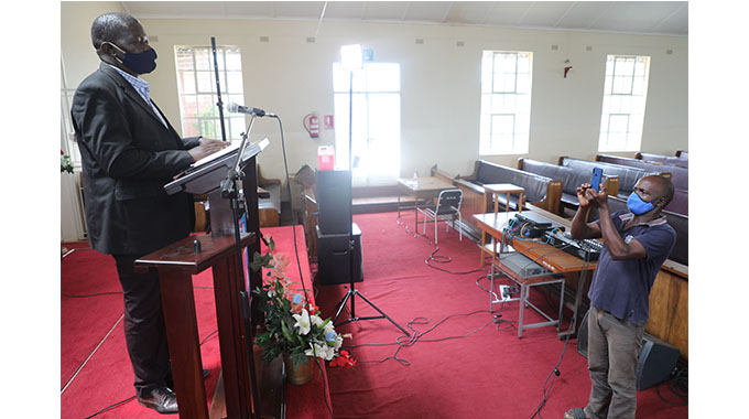 Brethren in Christ Church Senior Pastor Rev Ndabezinhle Nyathi is live streamed on Facebook as he preaches in an empty church in Bulawayo in line with the lockdown regulations