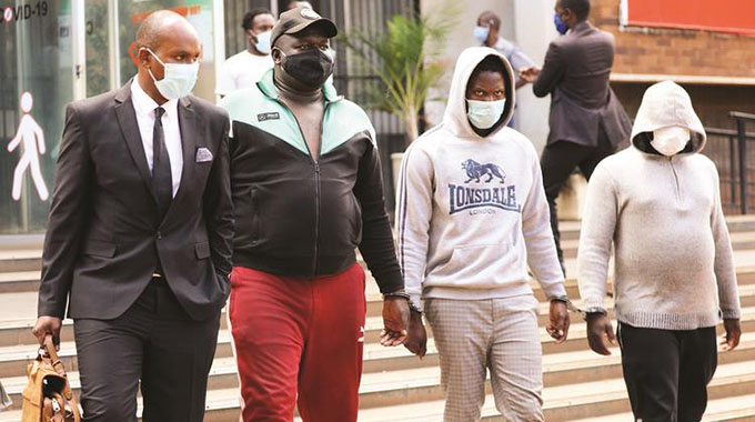 DJ Fantan, real name Arnold Kamudyariwa (second from left) and Levels, real name Tafadzwa Kadzimwe, (second from right) appear at the Harare Magistrates’ Courts. — Picture: Lee Maidza