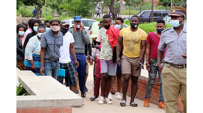 Lockdown violators who were arrested at a birthday party on Sunday in Nkulumane arrive at the Western Commonage Magistrate’s Court in Bulawayo yesterday