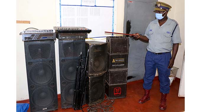 Nkulumane Officer incharge Chief inspector Alexius Munkuli with confisticated property from an illegal birthday party