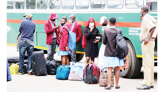 Ordinary and Advanced Level candidates wait to be ferried to school to finish writing their examinations at the City Hall car park yesterday