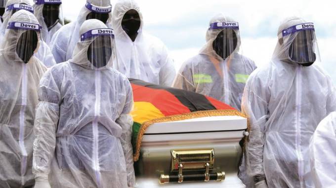 Pallbearers carry the casket bearing the national hero Lt Gen Douglas Nyikayaramba (Rtd) before burial, at the National Heroes Acre. — Pictures: Tawanda Mudimu
