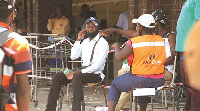 Illegal money changers enjoy brisk business outside Pick n Pay supermarket in Bindura recently. — Picture: Fortune Hamandawana