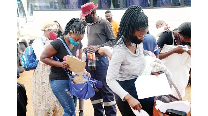 Zimbabwean ex-refugees from Botswana retrieve their particulars as they arrive at the International Organisation for Migration (IOM) centre at the Plumtree border post yesterday (Picture By Dennis Mudzamiri)