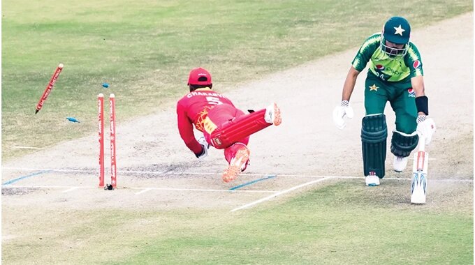 Regis Chakabva (left) runs out Pakistan dangerman Babar Azam to set off the visitors’ collapse during the second T20 International in Harare yesterday. Zimbabwe won the match by 19 runs to level the series 1-1 with a match to go
