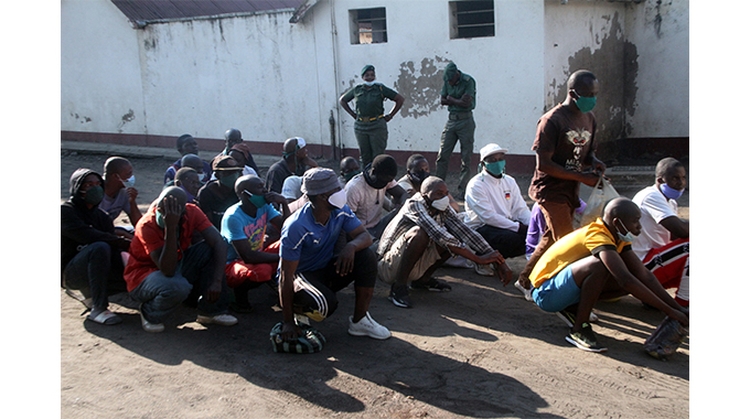 Inmates released under the Presidential Amnesty wait for their departure from Bulawayo Prison yesterday